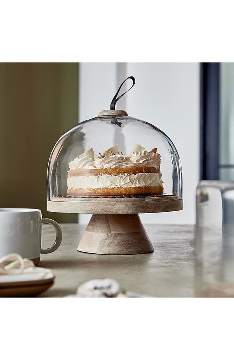 Show off your favorite baked treats in this mango wood cake stand that features a glass dome. 12 1/2" height Glass/mango wood Hand wash Imported Cake Stand In Kitchen, Cake Dish Decor Ideas, Cake Stand With Cover, Unique Cake Stands, Dome Cake, Cupcake Factory, Cake Stand Ceramic, Creative Brands, Wood Cake Stand