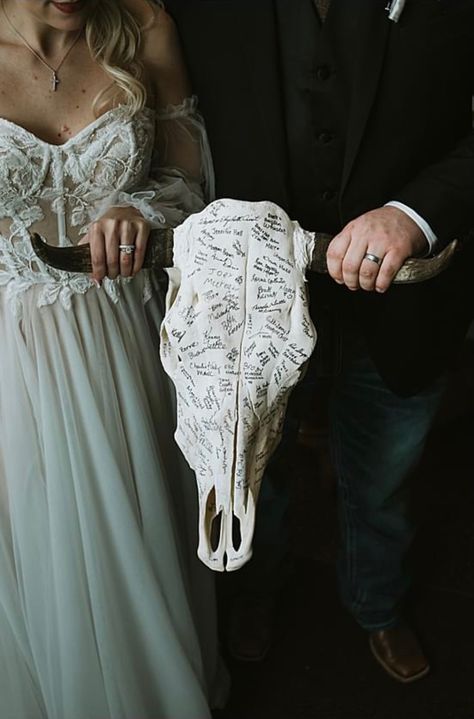 Signed steer skull as a guest book! Photo by: Courtneylynn Photography Gothic Wedding Guest Book Ideas, Country Wedding Guest Sign In, Cow Skull Signing Wedding, Country Meets Goth Wedding, Bull Skull Wedding Sign In, Skull Guest Book Wedding Ideas, Deer Skull Wedding Decor, Age Gap Wedding Photos, Spooky Western Wedding