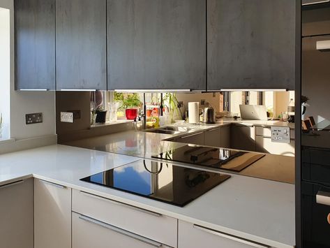 Bronze mirror shown here installed by Southern Counties Glass in a modern kitchen. Kitchen Mirrored Backsplash, Bronzed Mirror Splashback, Tinted Mirror Backsplash, Smokey Mirror Splashback, Kitchen Mirror Splashback Ideas, Backsplash Mirror Kitchen, Bronze Mirror Splashback Kitchen, Bronze Splashback Kitchen, Mirror Behind Kitchen Sink