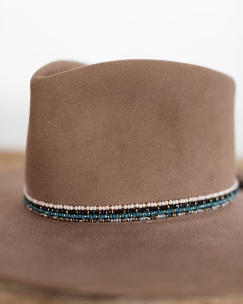 This hat band mixes beautiful faceted glass beads with brass accents to create a subtle sparkle to add to your hat. Material: Faceted glass beads & brass beads Dimensions: 21" beaded length Closure: Adjustable slide closure Color Options: Black, Gray, Beige, Blue Handmade by Crossbow in the mountains of Telluride, CO. Western Beaded Hat Bands, Seed Bead Hat Band Patterns, Cowboy Hat Bands Diy, Beaded Hats Native American, Beaded Hat Brim, Burned Hats, Cowboy Hat Band, Hat Painting, Glass Hat