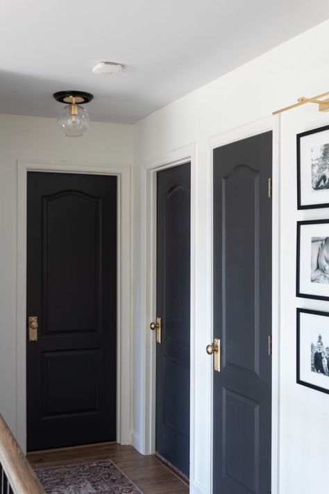 Black Door Hallway Decor, Blue Interior Doors Hallways, Dark Door Hallway, Make Doors Look Expensive, Black Interior Doors Small House, Hall With Black Doors, Black Interior Doors Dark Floors, Hallway All One Color, White Hall Black Doors