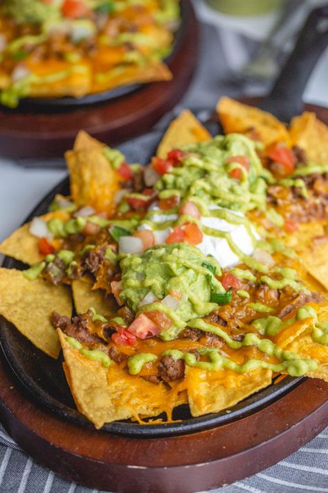 These restaurant style beef nachos are a great way to celebrate all trash fires in life: with chips, seasoned beef, cheese, and more, baked easily in cast iron or on a sheet pan in the oven. Top it with a spicy homemade green fire sauce. Canning Refried Beans, Best Chips, Bean Salsa, Nachos Beef, Dumpster Fire, Corn Chips, Cooked Veggies, Spicy Sauce, Refried Beans