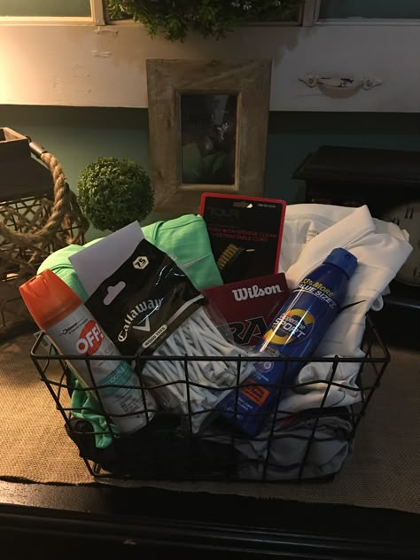 Golf basket for my husband's birthday. A couple outfits, sunscreen, bug spray, tees, golf balls, and a gift certificate for 18 holes and a cart for 2 people! He loved it! #golfbasket #golfer #bestwifeever #golfbirthday Golf Theme Basket Ideas, Golf Gift Basket Ideas Diy, Golf Auction Basket, Golf Gift Ideas For Boyfriend, Golf Birthday Gifts For Boyfriend, Golf Themed Gift Baskets, Boyfriend Golf Gifts, Gift Ideas For Golfers For Him, Golf Gift Basket Ideas For Men