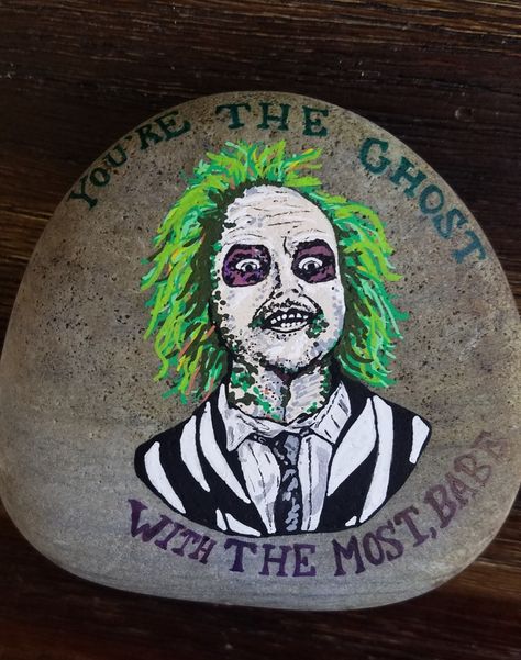 Beetlejuice rock painted by Rebeca Page Scary Painted Rocks, Beetlejuice Painted Rocks, Beetlejuice Rock Painting, Scary Paintings, Arts And Crafts Aesthetic, Rock Painting Supplies, Halloween Rocks, Stone Art Painting, Halloween Painting