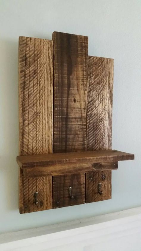 "This wall shelf unit was made entirely with reclaimed wood from used shipping pallets. Each board is hand picked to create this visually stunning and yet functional piece of wall art! This piece is perfect to have in your entryway, mudroom or hallway. Use it to hang your keys or even your fur babies leash. Comes ready to hang. Mounting hardware is already installed on the wall shelf. Because this piece is made from reclaimed wood no two are alike and each piece of wood has a history with differ 1 X 6 Wood Projects, Entry Way Shelf, Pallet Wood Shelf, Wooden Pallet Shelves, Shelf Entryway, Bullet Crafts, Pallet Wood Shelves, Outdoor Pallet, Pallet Shelf