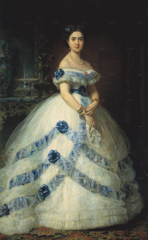 The Marquesa wears a spectacular half-dome shaped dress with a natural waistline set off by belt in this 1868 Madrazo y Kunz portrait. Tulle can be used dramatically in evening dresses as the Marquesa and her designer apparently knew. The bands of blue around her skirt are under the tulle, but the rosettes are above it. Gaun Abad Pertengahan, 1860 Fashion, Basic Fashion, 19th Century Fashion, Old Dresses, Blue And White Dress, Vestidos Vintage, Historical Costume, Historical Dresses