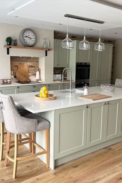 This calming kitchen has brought the essence of nature indoors with uplifting hues, natural textures, and warm tones. The beautiful Shaker Chelsea cabinets combined with the silky-smooth Ermine Sage Green offer a calming vibe and peaceful quality. To elevate the look and feel of this kitchen are the sparkling Quartz worktops in an Aspen Ice finish. Calming Kitchen, Green Country Kitchen, Wren Kitchens, Sage Kitchen, Green Kitchen Designs, Wren Kitchen, Open Plan Kitchen Dining Living, Beautiful Kitchen Cabinets, Kitchens Cabinets