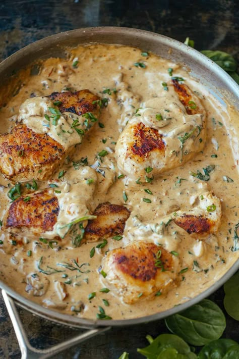 This easy Tuscan Chicken recipe pairs chicken breasts with mushrooms, sun-dried tomatoes, and spinach, all in an irresistible cream sauce. Tuscany Chicken Recipe, American Chicken Recipes, Chicken Tuscan, Creamy Tuscan Chicken Recipe, Tuscan Chicken Recipe, Natashas Kitchen, Popcorn Chicken Recipe, Creamy Tuscan Chicken, Chicken Recipes Video