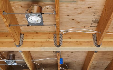 A recessed light installed between two floor joists in a ceiling. Drop Ceiling Lighting Ideas, Diy Recessed Lighting, How To Install Recessed Lighting, Basement Lights, Drop Ceiling Lights, A Frame Ideas, Canned Lighting, Drop Ceiling Grid, Spring View