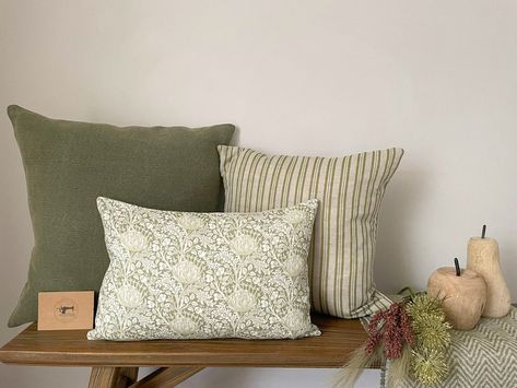 Beautiful natural & green modern farmhouse style linen cushion covers available as a bundle including: 1 x NINA 50cmx50cm 1 x EVELYNN 45cmx45cm 1 x MARGAUX 30cmx45cm All of these cushion covers are backed in Laura Ashley Austen Natural fabric with invisible zips along the bottom edge for ease of removal. These cushion covers are spot or dry clean only and should be ironed on medium heat. DELIVERY OPTIONS: If you wish to purchase the cushion covers only, select standard delivery at checkout. If y Cushion Sets Living Rooms, Beige And Green Home Decor, Cushions For Sofa, Living Room Green Colour Schemes, Modern Farmhouse Cushions, Cushions For Dark Green Sofa, Farmhouse Cushions, Cushion Colour Combinations, Cushion Arrangement Sofa