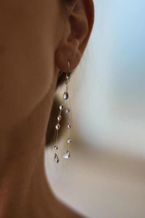 Water drop like earrings made of UV resin on monofilament line with stainless steel hooks.   Perfect for everyday wear or formal wear as they look like crystals. *Important* Keep in mind that every earring is made to order and there are no two same earrings. Every drop is unique and small changes are possible when it is handmade.  I always try my best to make it as similar as possible to the one you ordered.  Thank you! Rain Drop Jewelry, Water Droplet Earrings, Minimalist Dangle Earrings, Resin Drop Earrings, Water Drop Jewelry, Raindrop Jewelry, Queer Jewelry, Waterdrop Earrings, Water Earrings