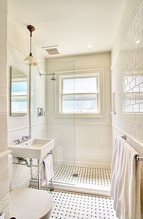 Gorgeous classic bathroom design with modern white porcelain sink with polished nickel base, white carrara marble basketweave tiles floor, glossy white subway tiles backsplash shower surround, open frameless glass shower and pendant. Classic Tile Combinations, 1890s Bathroom Tile, Subway Tile Master Bath, Bathroom Tile Classic, Tiny White Bathroom, Period Bath, Period Bathroom, England Cottage, Makeover Kamar Mandi