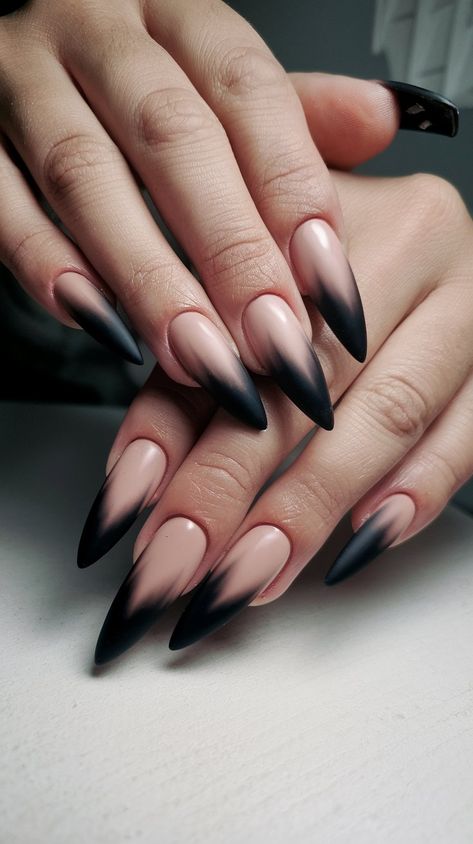 Elevate your nail game with these stunning stiletto acrylics! Featuring a sophisticated beige base that transitions into a sleek black matte gradient, these long nails exude elegance and modern flair. Perfect for any occasion, from a night out to professional settings, they’ll make your fingertips the center of attention. Show off this chic design on a clean white surface for a truly striking look! #acrylicnails #nailsdesign #octobernails ##nailsinspo Black Sweater Nail Designs, Dark Pointy Nails, Goth Ombre Nails, Nude And Black Nails Almond, Black Beige Nails, Black Fade Nails, Edgy Winter Nails, Stilleto Nail Idea, Stiletto Acrylic Nails Designs