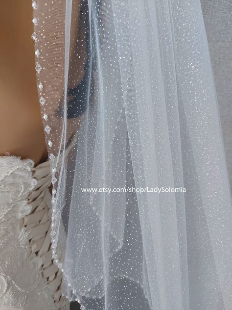 "The Glitter Pearl Bridal veil . On the photo length a veil 36\". There is a comb at the top of the veil to secure it on the head. This veil is available in a variety of lengths. I can make custom veil for you with length and width that you specify from the style you like. This veil is available in white and ivory. If you have any questions please send me a message, I will be happy to discuss details. Width 60 \" (150cm) 24\" Elbow length(60cm) 36\" Fingertip length (90 cm) READY TO SHIP LIGHT I Veil Glitter, Bridal Vail, Glitter Veil, Unique Wedding Veils, Rhinestone Veil, Sparkle Veil, Beaded Veil, Ship Light, Custom Veil