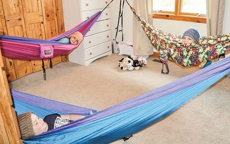 The Mason kids started sleeping in hammocks last summer, and now prefer their hammocks to beds. Sisters Lily, 7, (foreground), Faith, 6, (left) and Danica, 10, (right) share a room. Instead of making beds in the morning, they simply fold up their hammocks, leaving the bedroom open for the kids to play. Lily made hats so the girls’ hair doesn’t get staticky. Hammock Room, Active Playroom, Hammock In Bedroom, Sleeping Hammock, Kids Hammock, Hammock Stands, Hammock Bed, Bonus Rooms, Above Bed