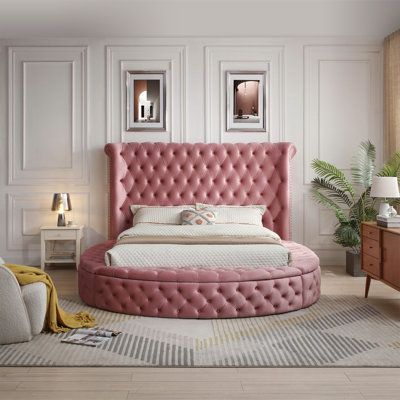 Modernize your bedroom with the Upholstered Round Storage Bed. With its lavish movie star contemporary design, this centerpiece adds excitement to your bedroom décor. Crafted with metal framework, wood slates and premium foam padded, and deep button tufted velvet upholstery throughout in a round-shape silhouette. Storage side-ottomans on three sides offer convenient storage space as it adds to the look. The nail-head trim design of the upholstered headboard brings an artistic atmosphere to your Round Bed Set, Round Bed Frame Ideas, Bedroom Round Bed, Round Bed Ideas, Round Bed Aesthetic, Round Bed Bedroom, Circular Beds, Round Bed Designs, Pink Bed Frame