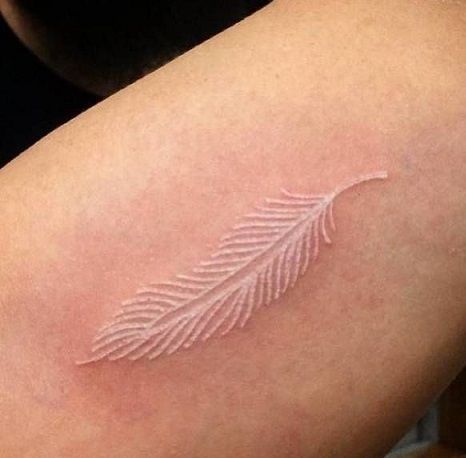 Top 9 Phenomenal White Tattoo Designs Literary Tattoos, White Ink Tattoos, White Feather Tattoo, White Feather Tattoos, Mother Nature Tattoos, Ankle Tattoo Small, Feather Tattoo Design, White Ink Tattoo, Triangle Tattoos