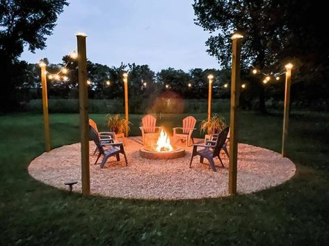 24 Fire Pit Ideas in Your Backyard for Perfect Summer Nights Round Gravel Fire Pit Area, Stone Fire Pit Backyard, Rock Fire Pit Area, Lights Around Fire Pit, Fire Pit With Lights, Simple Fire Pit Ideas, Fire Pit With Swings, Firepits Backyard Landscaping, Fire Pit Ideas Backyard On A Budget