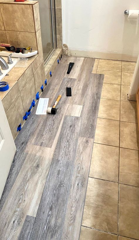 Learn how to install waterproof vinyl planks over existing flooring! Lifeproof Bathroom Floor, Vinyl Flooring Wall Ideas, Luxury Vinyl Plank Over Ceramic Tile, Laminate Over Tile Floor Bathroom, Laying Vinyl Flooring Over Ceramic Tile, Vinyl Plank Flooring Ideas House, Laminate Wood Flooring Over Ceramic Tile, Cover Floor Tiles, Vinyl Plank Over Tile Floor