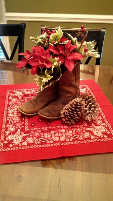 Cowboy Christmas boot centerpiece Texas Themed Christmas Decorations, Western Xmas Decor, Cowboy Christmas Table Decorations, Cowboy Boot Christmas Decor, Christmas Western Decorations, Cowboy Themed Christmas Party, Western Christmas Centerpiece Ideas, Christmas Western Decor, Country Christmas Theme Party