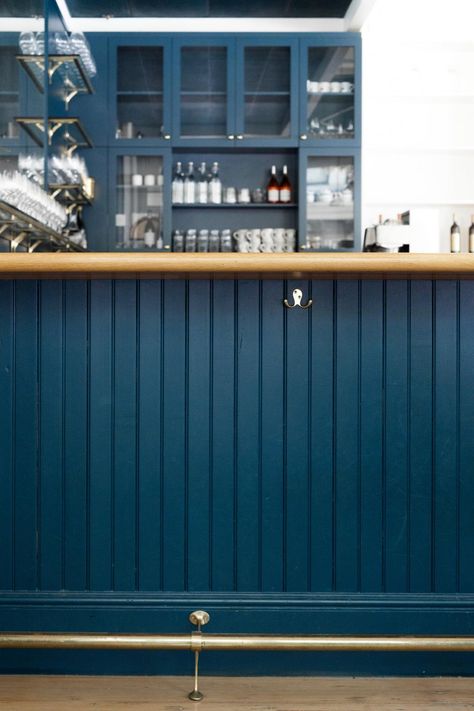 Dark blue bar at the Little London Plane in Seattle. Nautical Bar Design, Dark Blue Coffee Shop, Blue Cafe Aesthetic, Blue Coffee Bar, Blue Coffee Shop, Dark Blue Bar, Shiplap Bar, Blue Bakery, Nautical Bar