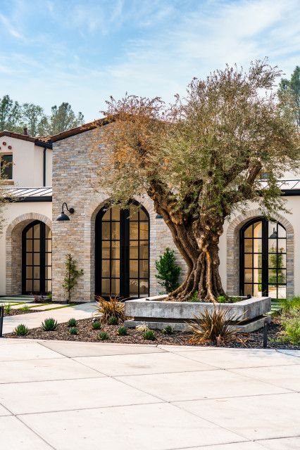 Ranch Mediterranean Homes, Mediterranean Stone House Exterior, Santa Barbara Modern Home, Mediterranean Brick House Exterior, Medditeranean Front Door, Mediterranean Front Entrance, Mediterranean Style House Exterior, Mediterranean Front Doors Entrance, Mediterranean Homes Exterior One Story