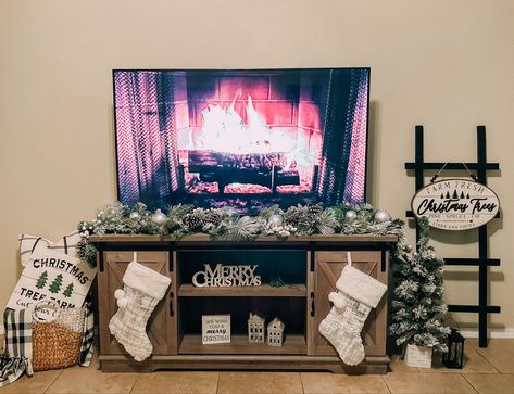 Christmas Decor Under Tv Stand, Christmas Living Room Tv Stand, Under The Tv Christmas Decor, Tv Fireplace Christmas Decor, Stocking On Tv Stand, Christmas Decorations For Tv Stand, Entertainment Stand Christmas Decor, Christmas Tv Unit, Entertainment Center Christmas Ideas