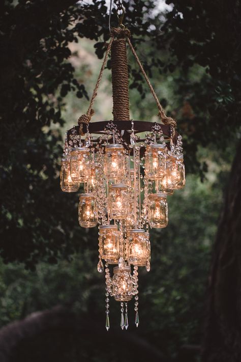 rustic bling!  I could do this with the mason jar/wagon wheel chandelier I made! ขวดโหล Mason Jar, Dekorasi Maroko, Chandelier Wedding Decor, Jar Chandelier, Mason Jar Chandelier, Diy Lampe, Wedding Chandelier, Rustic Mason Jars, Diy Outdoor Decor