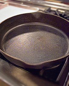 To keep a seasoned cast-iron pan in good condition, simply wipe it with a paper towel and a little oil after each use to clean it. If there are stuck-on food particles, use hot water and a brush or nylon scouring pad to clean them away (never use soap). If necessary, pour some water into the pan, and boil it on top of the stove for a few minutes to eliminate stubborn food pieces. Dry and reseason the pan between washings. Cast Iron Pan Care, Storage Workbench, Cleaning Cast Iron Pans, Wood Shops, Seasoned Cast Iron Pan, Cast Iron Care, Cast Iron Pans, Martha Stewart Home, Cast Iron Cleaning