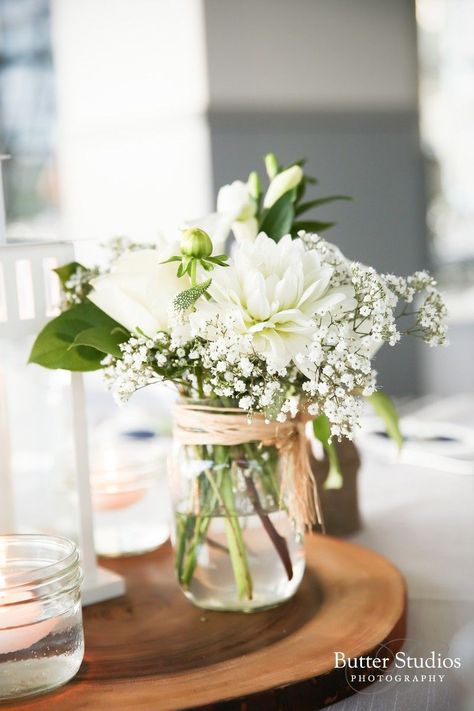 Simple table decor. Affordable and simple flower arrangement. #wedding #doljanchi #tabledecor #simpleflowers Ranunculus Wedding Centerpieces, Jam Jar Flowers, White Flower Centerpieces, Mason Jar Flower Arrangements, Wedding Table Toppers, Wedding Jars, Wedding Centerpieces Mason Jars, White Floral Arrangements, White Flower Arrangements