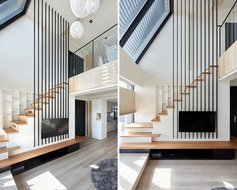 This modern apartment uses black poles to provide a safety element for the stairs, replacing the need for a handrail on the higher section. #Stairs #StairDesign #TVMount High Ceiling Living Room Modern, Loft Staircase, High Ceiling Living Room, Stairs In Living Room, Stairs Design Modern, Minimalist Apartment, Modern Stairs, 아파트 인테리어, Loft House