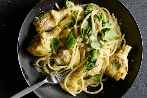 Lemon zest, lemon juice, Parmesan and basil come together for a silky and vibrant sauce that makes this weeknight-friendly pasta sing The addition of roasted artichoke hearts adds texture and complements the zestiness of the dish There’s no better time than a weeknight to embrace canned or frozen artichoke hearts, as they are immensely less work than whole fresh ones, and they roast beautifully — and effortlessly — in a hot oven Roasted Artichoke Hearts, Lemon Parmesan Pasta, Roasted Artichokes, Lemon Spaghetti, Roasted Artichoke, Artichoke Recipes, Nyt Cooking, Cooking Guide, Everyday Food