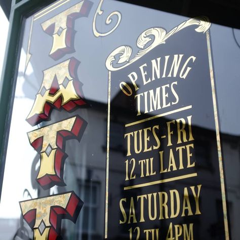 Hand painted and gold leaf window sign for Timeless Ink Tattoo in Salisbury. #signwriting #tattoo Tattoo Shop Front Window, Hand Painted Window Signs, Hand Painted Business Sign, Hand Painted Tattoo Sign, Gold Leaf Window Lettering, Gold Foil Window Signage, Environmental Signage, Library Door, Vintage Handpainted Sign