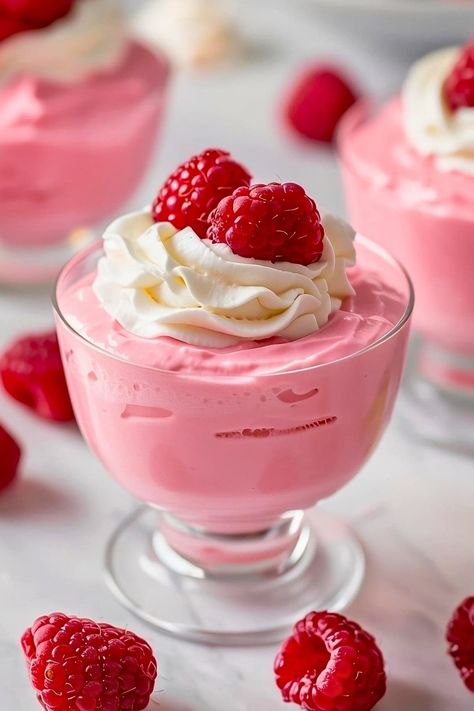 This traditional raspberry mousse recipe uses real raspberries for an intensely fruity flavor. It's pretty in pink, light, airy, and too good to miss. Pink Mousse Cups, Raspberry Mousse Pie, What To Do With Mushy Raspberries, Raspberry Parfait Desserts, Easy Mouse Recipes, Fruit Mousse Recipes, Raspberry Mousse Cake Filling, Mousse Dessert Recipes, Yummy Recipes Dessert