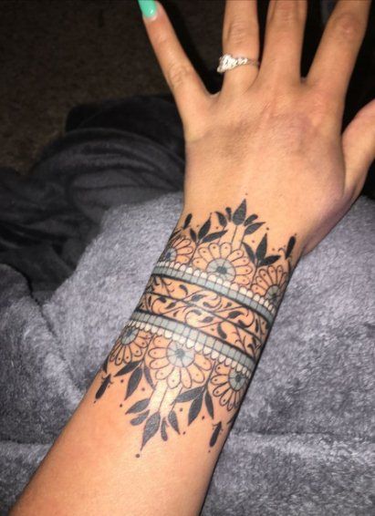 30+ Bold & Beautiful Tribal Tattoos For Women | Spiritustattoo.com Cuff Tattoo Wrist, Wrist Cuff Tattoo, Mandala Wrist Tattoo, Wrist Band Tattoo, Wrist Tattoos Girls, Unique Wrist Tattoos, Tattoo Band, Cuff Tattoo, Flower Wrist Tattoos