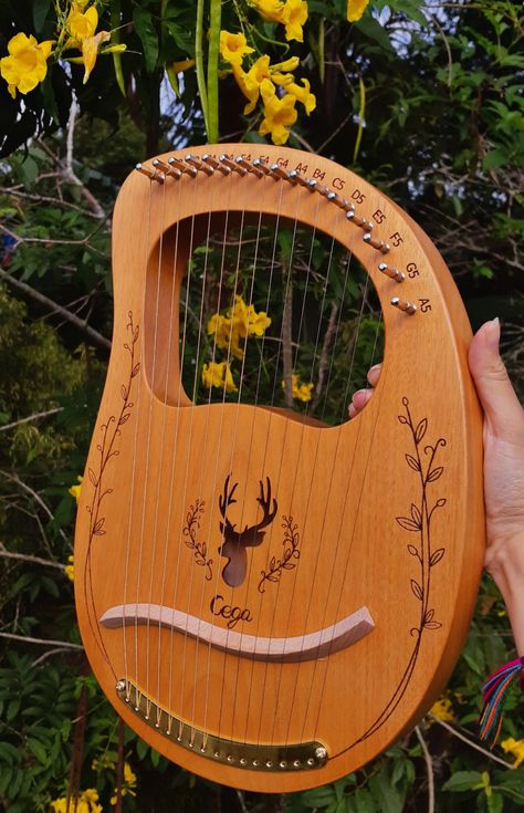 a beautiful wooden lyre, such a magic instrument. green leaves and yellow flowers are behind it! Celtic Instruments, Pretty Instruments, Goal Board, Celtic Music, Vision Board Goals, Daily Diary, I'm In Love, I Can't Wait, Im In Love