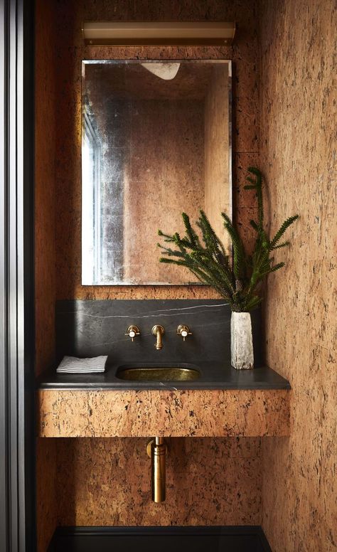 This simple but sexy cork-lined powder room from House Beautiful is the ultimate modern bathroom. I love the elegant simplicity. #powderroom #powderroomideas #powderroomwalls #powderroomdesign Moody Bathroom, West Village Apartment, Cork Wallpaper, Wash Room, Reclaimed Wood Beams, Cork Wall, Bathroom Trends, Mug Design, Fireplace Decor