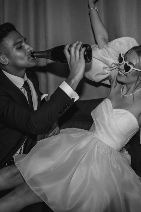 Bride in puff sleeve short wedding reception dress with retro wedding sunglasses celebrating with the groom drinking champagne from the bottle | wedding day | disco wedding | retro sunglasses | short wedding dress | reception wedding dress | wedding drinks | Lindsey Ria Photography Retro Bride Photoshoot, Short Wedding Dress Sunglasses, Short Wedding Dress Photoshoot, Bride And Groom Sunglasses, Bride Sunglasses Wedding, Retro Wedding Photoshoot, Retro Wedding Reception, Short Wedding Reception Dress, Destiny Wedding