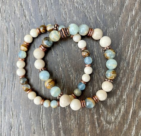 "These beautiful bracelets promote tranquility, yet are grounding. Both are made with Argentinian Lemurian Aquatine Calcite and White Fossil Jasper stone beads. One is made with 6mm beads, the other with 8mm beads. The blue green banded calcite beads have different patterns throughout with a brown matrix, making them a perfect fit with the off-white fossil jasper beads and copper accents. Choose your bracelet, with either 6mm or 8mm beads. Together, they make a lovely stack, but are equally beau Blue And Green Bracelet Ideas, Chalcedony Bracelet, Vintage Jewelry Ideas, Color Bracelet, Blue Onyx, 8mm Beads, Beautiful Bracelets, Bracelets Design, Copper Accents