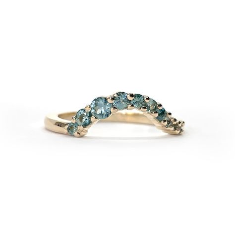 Originally inspired by the silky, cascading waves of the Adriatic Sea, the fully customizable WAVE Ring is the definition of timeless. Wear it on it’s own or stack it with your engagement ring; there is simply no wrong way to wear it! Details:☞ 14k gold☞ Approx 0.50cttw fair-trade, teal blue Montana sapphires☞ Sizes 4 - 11 available (custom sizing available on request)☞ Fully customizable☞ Designed & made with love in Vancouver The WAVE band is completely customizable is an endless variety of ge Wave Band Ring, Ocean Inspired Engagement Rings, Ocean Rings, Blue Diamond Wedding Band, Wave Rings, Wave Wedding Band, Montana Sapphires, Traditional Wedding Bands, Ocean Ring