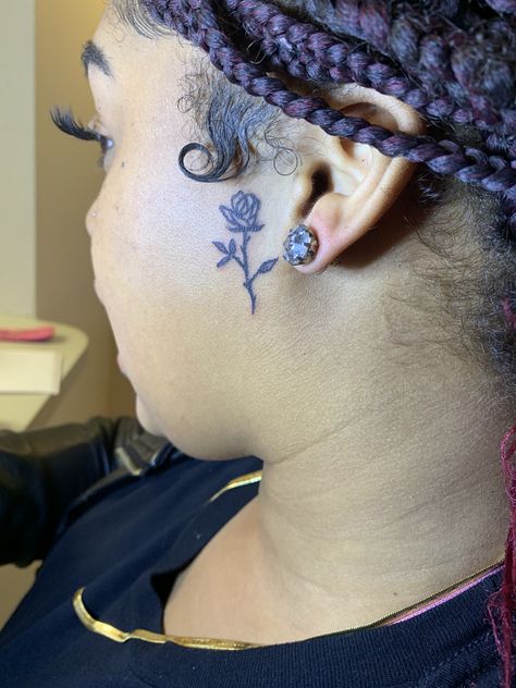 Small rose face tattoo Small Face Tattoos Black Women, Side Of Face Tattoo Black Women, Side Of Ear Face Tattoo, Small Rose Tattoo On Neck, Rose On Side Of Face Tattoo, Cover Up Face Tattoos, Heart Tattoo On Side Of Face, Small Side Burn Tattoos For Women, Rose Sideburn Tattoo