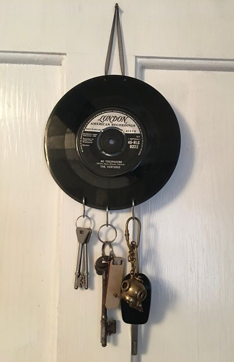 Funky key holder/hanger made from upcycled and repurposed old 7 inch singles. A unique way to keep your keys safe, and a real talking point for visitors!  You can also use it to hang necklaces from if you don't have keys!  You'll receive a mystery artist, and you can choose the colour of the centre.  The hanger will come with three hooks and black ribbon. Postage & packing is free to the UK, and worldwide post is available.  Your item will be gift wrapped, and I can write a wee note on the card Necklace Hanger, Apartment Decor Inspiration, Dream Room Inspiration, Room Makeover Inspiration, Cute Room Decor, Retro Home Decor, Vintage Vinyl, Cozy Room, Room Inspiration Bedroom