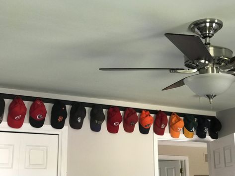 Great way to display the hats.  Very simple project! Pegboard Hat Rack, How To Display Ball Caps, Hat Memorial Display, Hat Shelves Ideas, Organize Hats On Wall, Baseball Hat Displays, Baseball Hat Collection Display, Hang Baseball Hats On Wall, Ball Cap Wall Display