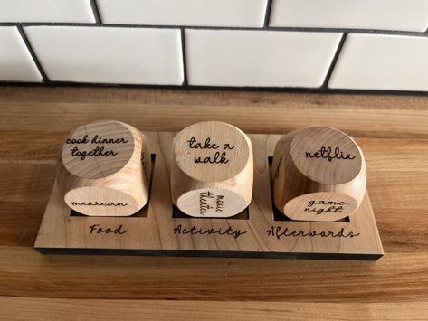 Never struggle to decide what to do for a date night again! Details: Dice are 1 1/2" in size Includes a stand for all 3 dice Date Night Dice Diy, Homemade Gifts For Partner, Wooden Dice Crafts, Wedding Gifts Ideas For Couple, Anniversary Crafts For Him, Wooden Anniversary Gifts For Him, Date Night Gift Ideas, Laser Wood Projects, Holiday Wood Signs