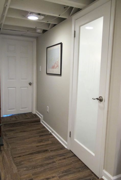 Cozy Chic Basement Reno with Exposed Painted Joists & Wood Tile Floors Open Ceiling Basement Bathroom, Frosted Basement Door, Privacy Glass Bathroom, Basement Apt Ideas, Chic Basement, Frosted Door, Basement Update, Glass Bathroom Door, Cheap Basement Remodel