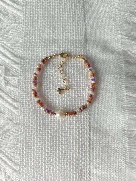 FOR OTHER DAINTY BEADED BRACELETS: https://www.etsy.com/ca/shop/ArtiChouXCanada?ref=seller-platform-mcnav§ion_id=46088511 Bracelet Length: 13-18cm (5.1-7 inches) with a 14k gold filled extender.  This bracelet features an assortment of cute caramel toned fall colors: orange, brown, cream, white, and 18k gold filled seed beads. It also contains a freshwater pearl.  Thread may be visible since it is a handmade product   SIZING  Wrap a soft measuring tape snugly around the widest part of your wrist. Add 1.27cm (0.5in) to that measurement to determine the right bracelet size.  MATERIALS  - Japanese MGB glass seed beads(2x4mm) - 18K gold filled beads of 2mm - Freshwater pearl - 14K gold filled extender  CARE INSTRUCTIONS   To maintain its radiance, gently clean the bracelet with a soft cloth an Fall Beads Bracelet, Beaded Bracelets Aesthetic, Fall Beaded Jewelry, Fall Bracelets, Small Bead Bracelet, Fall Bead, Autumn Bracelet, Homemade Bracelets, Brown Bracelet