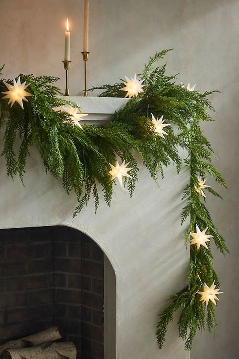 Simple, elegant designs with a focus on fewer, high-quality decorations. Neutral colors, like whites and earthy tones, paired with natural elements like pinecones and greenery, create a serene atmosphere. Classy Winter Decor, Christmas Greenhouse, Faux Cedar Garland, Stair Garland, Cedar Garland, Moravian Star, Star String Lights, Classy Christmas, Unique Christmas Decorations