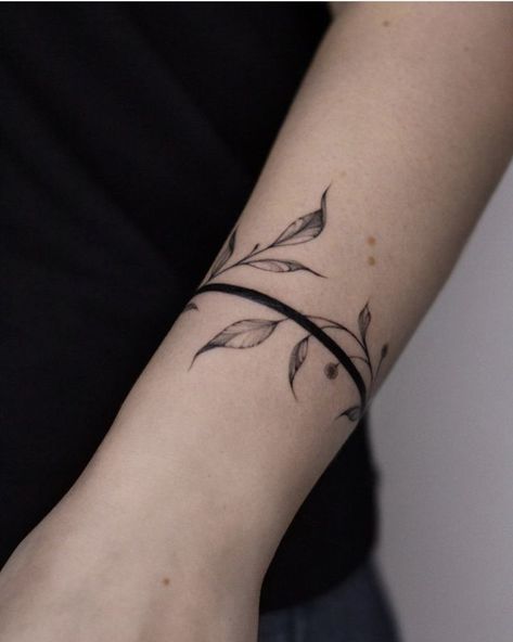 Simple Arm Band Tattoo For Women, Bracelet Tattoos For Women Arm, Women Arm Band Tattoo Ideas, Ankle Bracelet Tattoos For Women Wrap Around, Wrist Wrap Tattoos For Women Unique, Black Band Tattoo Women, Forearm Bracelet Tattoo, Leaf Arm Band Tattoo, Simple Bracelet Tattoo