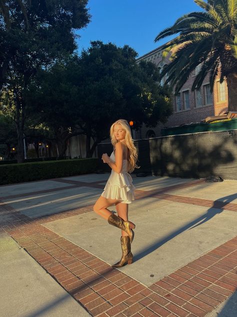 White Dress With Boots Country, Hoco Cowgirl Boots, Cowgirl Boots With Homecoming Dress, Hoco Dresses With Cowgirl Boots, Boots With Hoco Dress, Short Flowy Dress With Cowboy Boots, Sundress Country Concert, Sundress With Cowgirl Boots, Prom Dress And Cowboy Boots