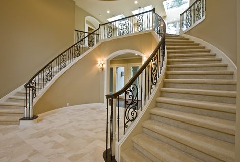 Wow your guests with a spectacular home entry featuring a gorgeous imperial staircase and distinct railing design. #customhomes #imperialstaircase #staircasedesign #railingdesign Beautiful Staircases Grand Entrance, Fancy Staircases Grand Entrance, Luxury Stairs Grand Staircase, Grand Spiral Staircase Luxury, Imperial Staircase, Railing Design, Staircase Design, Stairs Design, Railing